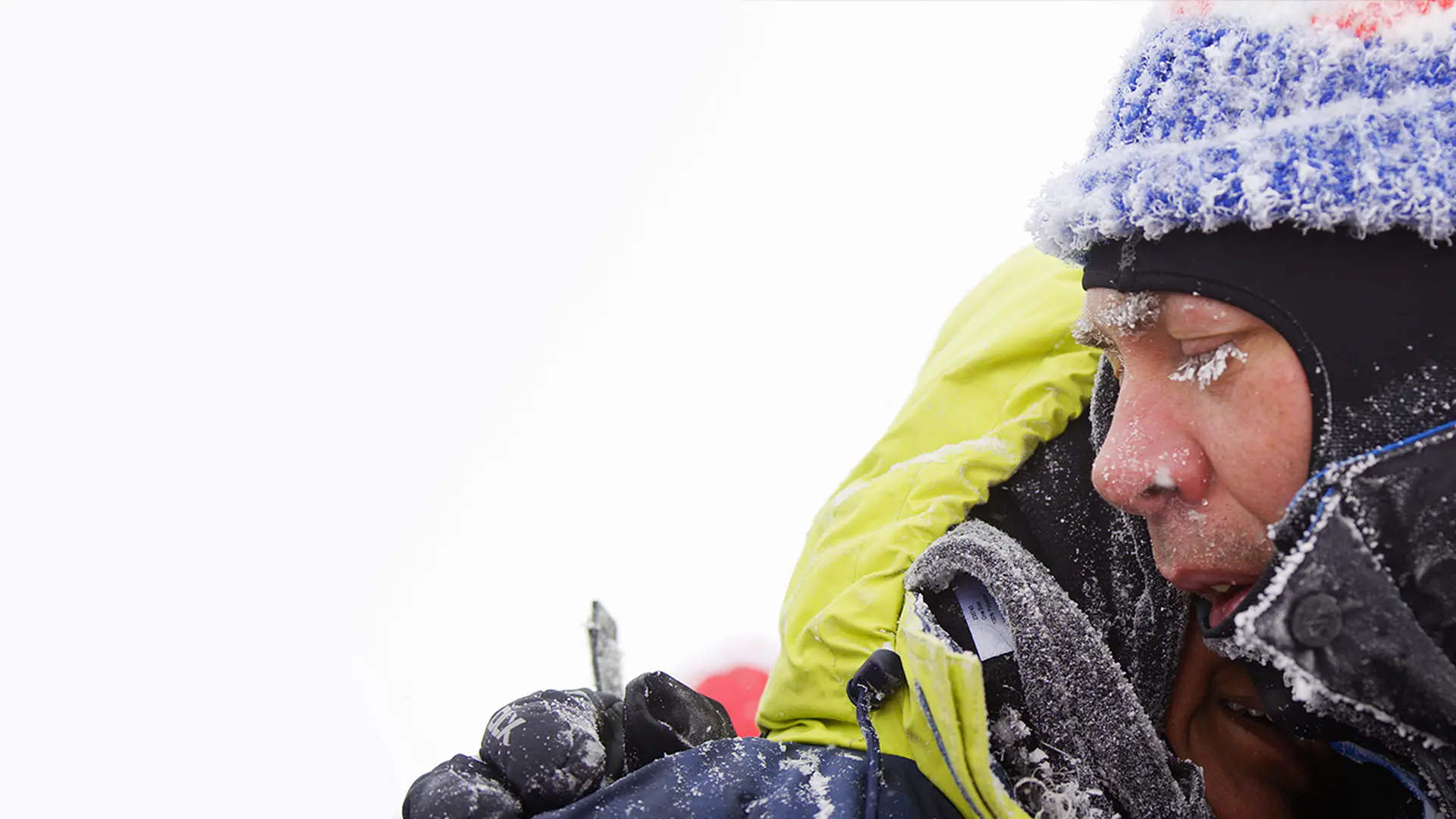 Two team members embrace at the summit of Kilimanjaro