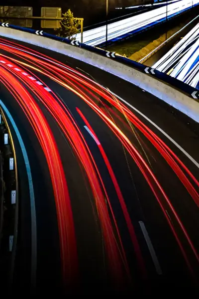 Car headlights and rear lights passing in opposite directions on a motorway