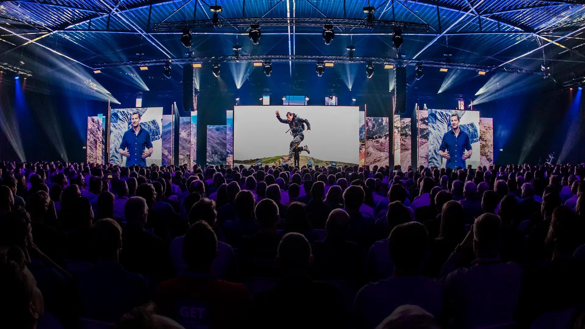 A presentation by Bear Grylls given to a large audience