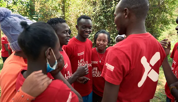 Kenyan children talking together, a photo from the BecomingX Foundation social impact project in Kenya.