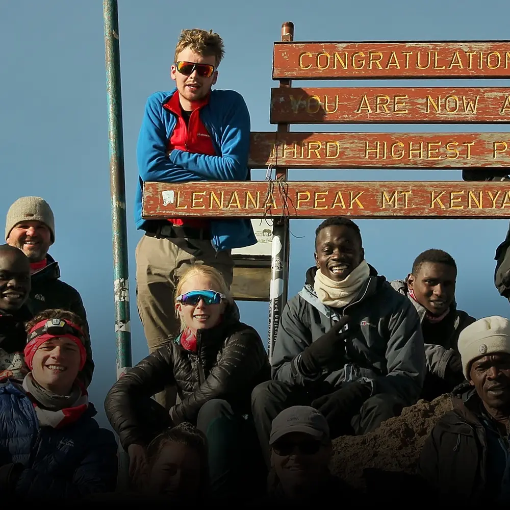 A group of students who have made it to the top of Mount Kenya on a BecomingX Education expedition.