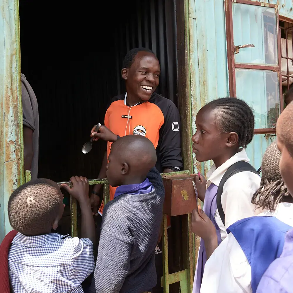 School children receiving food in one of the many local communities BecomingX have visited
